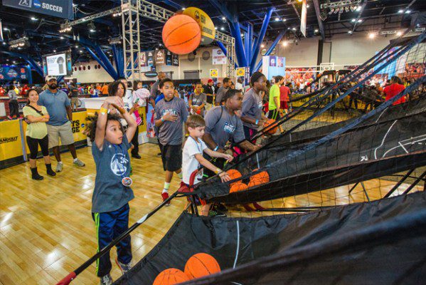 Kid tossing a basketball into the air at a tradeshow logistics expo