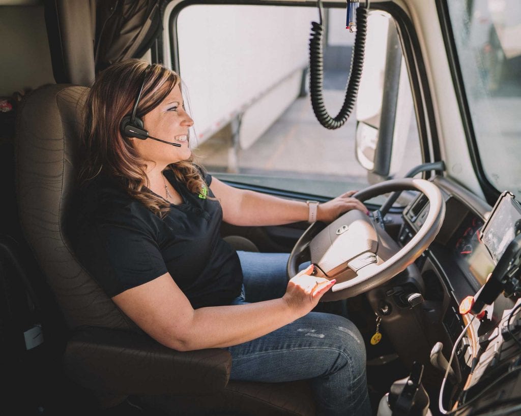 Woman driving a Full Tilt Logistics truck with high value shipments
